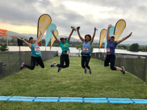 Runners jump over the finish line